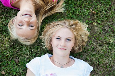 Overhead View of Teenage Girls Lying on Grass, Mannheim, Baden-Wurttemberg, Germany Stock Photo - Premium Royalty-Free, Code: 600-06939779