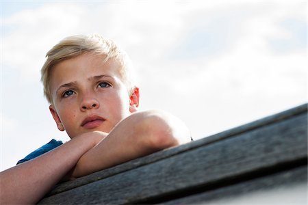 Close-up portrait of boy outdoors, looking into the distance, Germany Stock Photo - Premium Royalty-Free, Code: 600-06961049