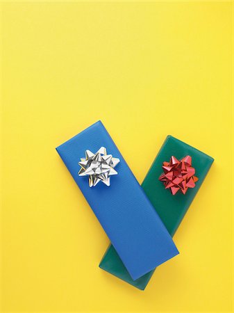 ribbon (material) - Gifts wrapped in colorful paper on yellow background, studio shot Stock Photo - Premium Royalty-Free, Code: 600-07067135