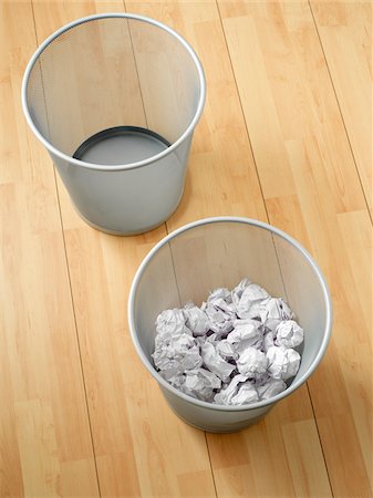 Overhead view of empty and used waste baskets on wooden floor, studio shot Stock Photo - Premium Royalty-Free, Code: 600-07067138