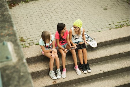 simsearch:700-05973468,k - Girls Sitting on Steps with Tablet Computers and Skateboard, Mannheim, Baden-Wurttemberg, Germany Stock Photo - Premium Royalty-Free, Code: 600-07117286