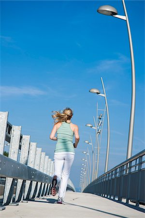 Young Woman Running, Worms, Rhineland-Palatinate, Germany Stock Photo - Premium Royalty-Free, Code: 600-07110556