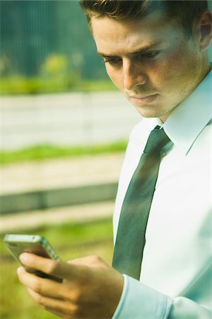 simsearch:600-07110828,k - Close-up of Businessman using Cell Phone, Mannheim, Baden-Wurttermberg, Germany Stock Photo - Premium Royalty-Free, Code: 600-07110822