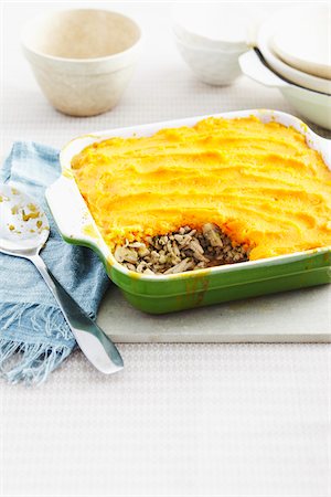 simsearch:600-06892689,k - Shepherds Pie in baking dish on table with serving spoon Stock Photo - Premium Royalty-Free, Code: 600-07156117