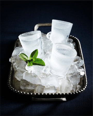 Shot Glasses made from ice on serving tray on black background, studio shot Stock Photo - Premium Royalty-Free, Code: 600-07156140