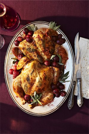 platter - Spatchcock Roast with Grapes on platter, studio shot Stock Photo - Premium Royalty-Free, Code: 600-07156170