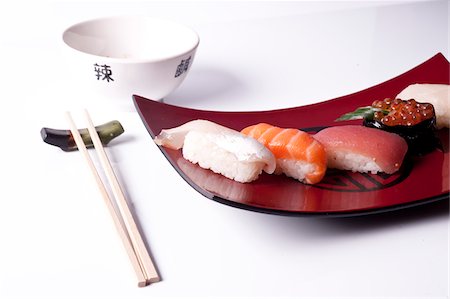 simsearch:600-05973291,k - Sushi Nigiri with Salmon, Tuna and Sea Bass with Chopsticks, Studio Shot Stock Photo - Premium Royalty-Free, Code: 600-07192122