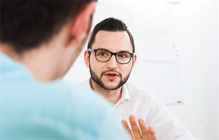 questions - Close-up of two young businessmen meeting and in discussion, Germany Stock Photo - Premium Royalty-Free, Code: 600-07200038