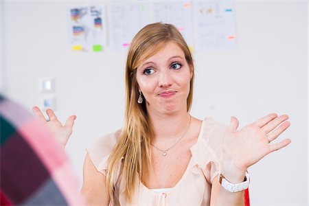 staff (female) - Close-up of young, blond businesswoman making hand gesture in meeting in office, Germany Stock Photo - Premium Royalty-Free, Code: 600-07202762