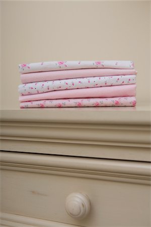 set (pair or group of things) - Stack of Pink Baby Blankets on Dresser in Nursery Stock Photo - Premium Royalty-Free, Code: 600-07232287