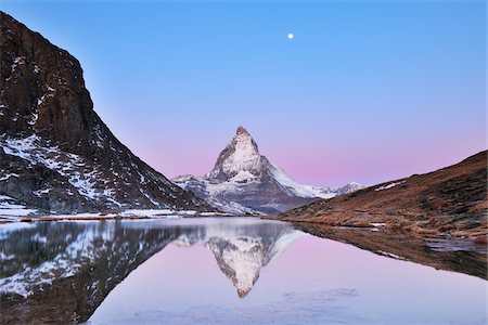 famous - Matterhorn reflected in Lake Riffelsee at Dawn with Moon, Zermatt, Alps, Valais, Switzerland Stock Photo - Premium Royalty-Free, Code: 600-07278756