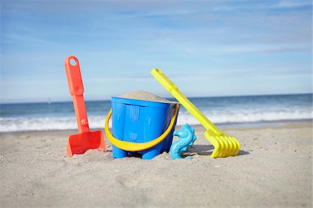 shovel (hand tool for digging) - Toy Bucket, Shovel and Rake in Sand at Beach, Saint-Jean-de-Luz, Pyrenees-Atlantiques, France Stock Photo - Premium Royalty-Free, Code: 600-07279375