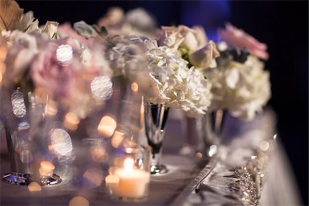 Close-up of flower arrangements in vases with candlelight on table at reception, Canada Stock Photo - Premium Royalty-Free, Code: 600-07311011