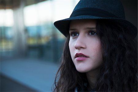 Close-up portrait of teenage girl outdoors, wearing fedora, Germany Stock Photo - Premium Royalty-Free, Code: 600-07311105