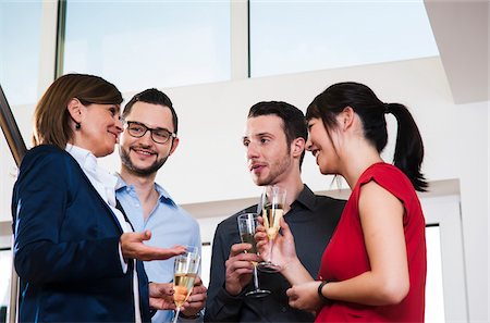 simsearch:600-05973117,k - Mature businesswoman toasting group of young business people with glasses of champagne, Germany Stock Photo - Premium Royalty-Free, Code: 600-07311405