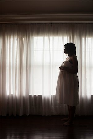 drapery - Silhouette of Pregnant Woman Looking out Window Stock Photo - Premium Royalty-Free, Code: 600-07311587