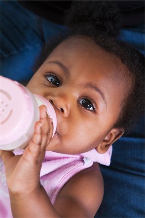 Close-up of Baby Girl Drinking Milk from a Bottle Stock Photo - Premium Royalty-Free, Code: 600-07368541