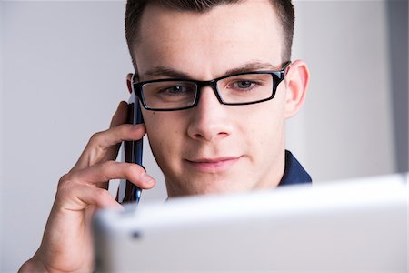 Young Man Working in Office, Mannheim, Baden, Wurttemberg, Germany Stock Photo - Premium Royalty-Free, Code: 600-07431260