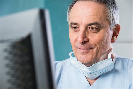 simsearch:700-07529229,k - Close-up of Doctor with Sugical Mask at Computer Stock Photo - Premium Royalty-Free, Code: 600-07487601