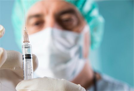 Close-up of Surgeon with Syringe Stock Photo - Premium Royalty-Free, Code: 600-07487612