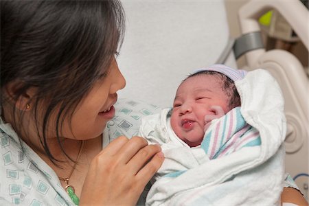 delivery room - Proud Mother holding Newborn Baby Girl for the First Time Stock Photo - Premium Royalty-Free, Code: 600-07529211