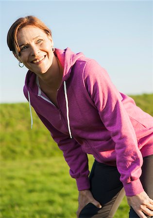 Close-up of mature woman taking a break from running outdoors, Germany Photographie de stock - Premium Libres de Droits, Code: 600-07584747