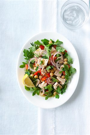 dinnerware - Overhead View of Salad with Red Onion, Chickpeas, Red Peppers, Tuna and Lemon Wedge, Studio Shot Stock Photo - Premium Royalty-Free, Code: 600-07784414