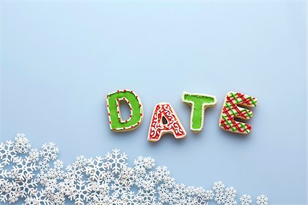 date (time) - Overhead View of Letter Cookies spelling DATE on Blue Background with Snowflakes Stock Photo - Premium Royalty-Free, Code: 600-07784419