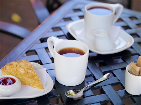 Two White Mugs of Tea on Patio Table with Scone and Jam, Dundas, Ontario, Canada Stock Photo - Premium Royalty-Free, Code: 600-07802971