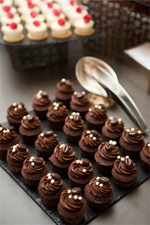 simsearch:600-07067653,k - Chocolate Cupcakes topped with Coffee Beans on Dessert Table at Wedding Reception Stock Photo - Premium Royalty-Free, Code: 600-07991680