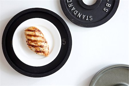 simsearch:600-06382994,k - Grilled Chicken breast on a white plate on top of a weight plate, studio shot on white background Stock Photo - Premium Royalty-Free, Code: 600-08002094