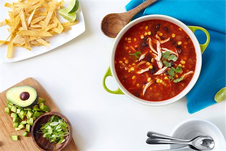 filled - Pot filled with chicken, tortilla, black bean soup with ingredients on the side, studio shot Stock Photo - Premium Royalty-Free, Code: 600-08002092