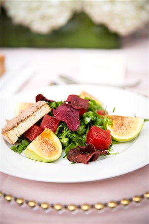 plated food - Close-up of gourmet salad of leafy greens with figs, watermelon cubes, beet chips and toast, at an event, Canada Stock Photo - Premium Royalty-Free, Code: 600-08002539