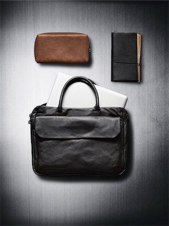 satchel - Bags and notebook on metallic background in studio Stock Photo - Premium Royalty-Free, Code: 600-08312059