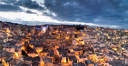 evening house - Scenic overview of congested houses of Sassi di Matera illuminated at dusk, one of the three oldest cities in the world, Matera, Basilicata, Italy Stock Photo - Premium Royalty-Free, Code: 600-08426551
