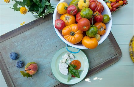 simsearch:600-07311268,k - Overhead View of Bowl of Heirloom Tomatoes and Plate of Feta Cheese and Fresh Basil Stock Photo - Premium Royalty-Free, Code: 600-08512595