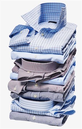 simsearch:600-08353424,k - Stack of multi coloured checked and striped shirts on white background, studio shot Stock Photo - Premium Royalty-Free, Code: 600-08567205