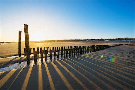 Wooden Breakwater on Beach at Low Tide at Sunrise, Domburg, North Sea, Zeeland, Netherlands Stock Photo - Premium Royalty-Free, Code: 600-08865352