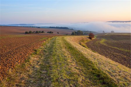 simsearch:600-08916150,k - Countryside with path and morning mist over fields at Grossheubach in Bavaria, Germany Stock Photo - Premium Royalty-Free, Code: 600-08973347