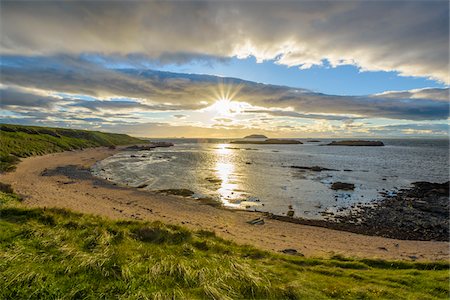 simsearch:700-03508663,k - Sun shining over bay with sandy beach at sunset in North Berwick at Firth of Forth in Scotland, United Kingdom Stock Photo - Premium Royalty-Free, Code: 600-08973407