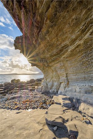 simsearch:841-07204601,k - Close-up of rock face of sea cliff with honeycomb weathering and sun shining over Loch Scavaig on the Isle of Skye in Scotland, United Kingdom Stock Photo - Premium Royalty-Free, Code: 600-08986271