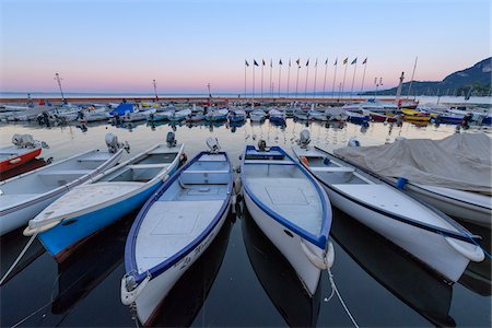 simsearch:862-07690164,k - Harbor marina with rows of docked fishing boats Lake Garda (Lago di Garda) at dawn in Garda in Veneto, Italy Stock Photo - Premium Royalty-Free, Code: 600-09022394