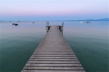 Wooden jetty on Lake Gardo (Lago di Garda) at dawn in Bardolino in Veneto, Italy Stock Photo - Premium Royalty-Free, Code: 600-09022415