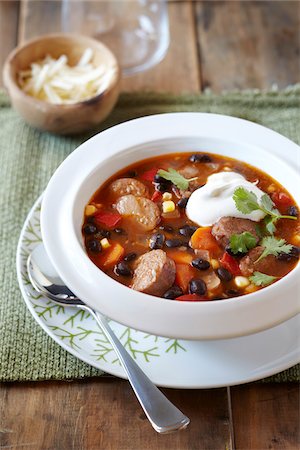 simsearch:600-06892689,k - Black bean and sausage soup topped with sour cream Stock Photo - Premium Royalty-Free, Code: 600-09119432