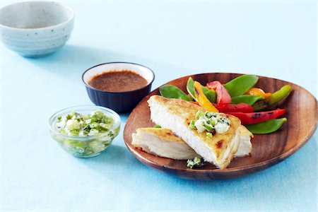 simsearch:600-06892689,k - Crispy fried tofu with green onion salsa served with sauteed snow peas and peppers and a dipping sauce Stock Photo - Premium Royalty-Free, Code: 600-09119444