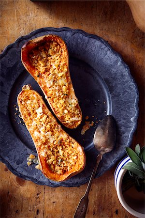 simsearch:600-07311268,k - Stuffed butternut squash baked with cheese and sage on a blue dinner plate Stock Photo - Premium Royalty-Free, Code: 600-09119474