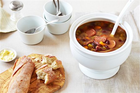 simsearch:600-06892689,k - Soup tureen of Hungarian Bean Soup with crusty bread on the side on a linen tablecloth Stock Photo - Premium Royalty-Free, Code: 600-09155465