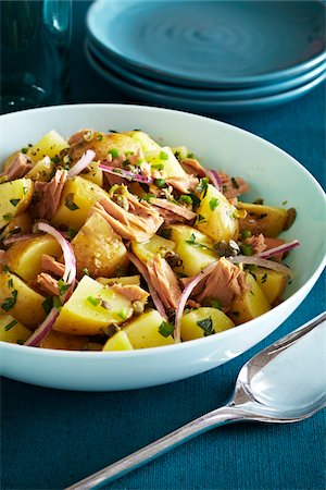 Potato salad with tuna, capers and purple onions on a teal background Stock Photo - Premium Royalty-Free, Code: 600-09155489