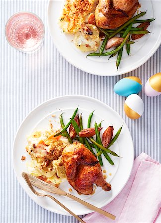 simsearch:600-07110444,k - Two plates with cornish hens, scallop potatoes and green beans for Easter dinner Stock Photo - Premium Royalty-Free, Code: 600-09155540