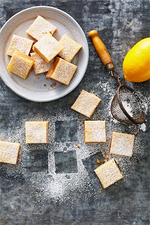 simsearch:600-07067653,k - Bowl of lemon squares with icing sugar on a grey metallic background Stock Photo - Premium Royalty-Free, Code: 600-09155574
